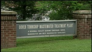 Facility entrance sign with plant's name and service area. 